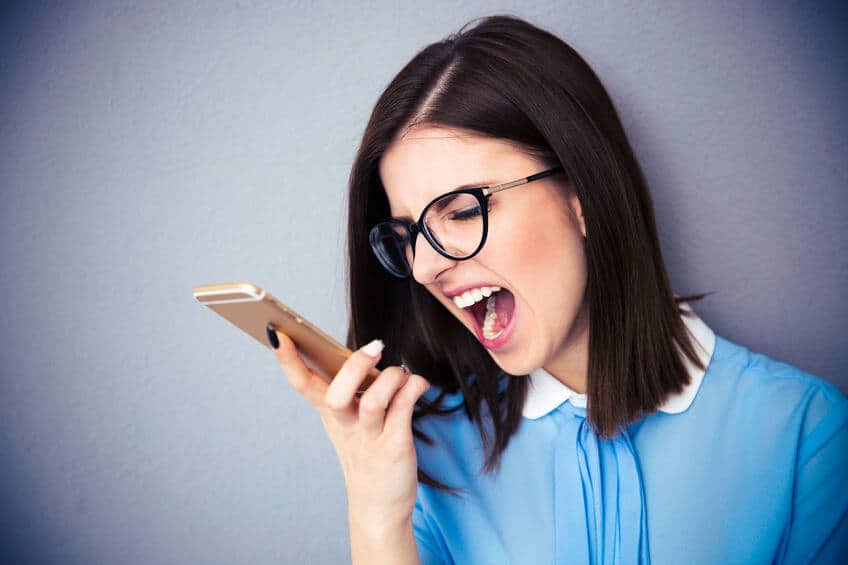 スマホ画面見て怒る女性
